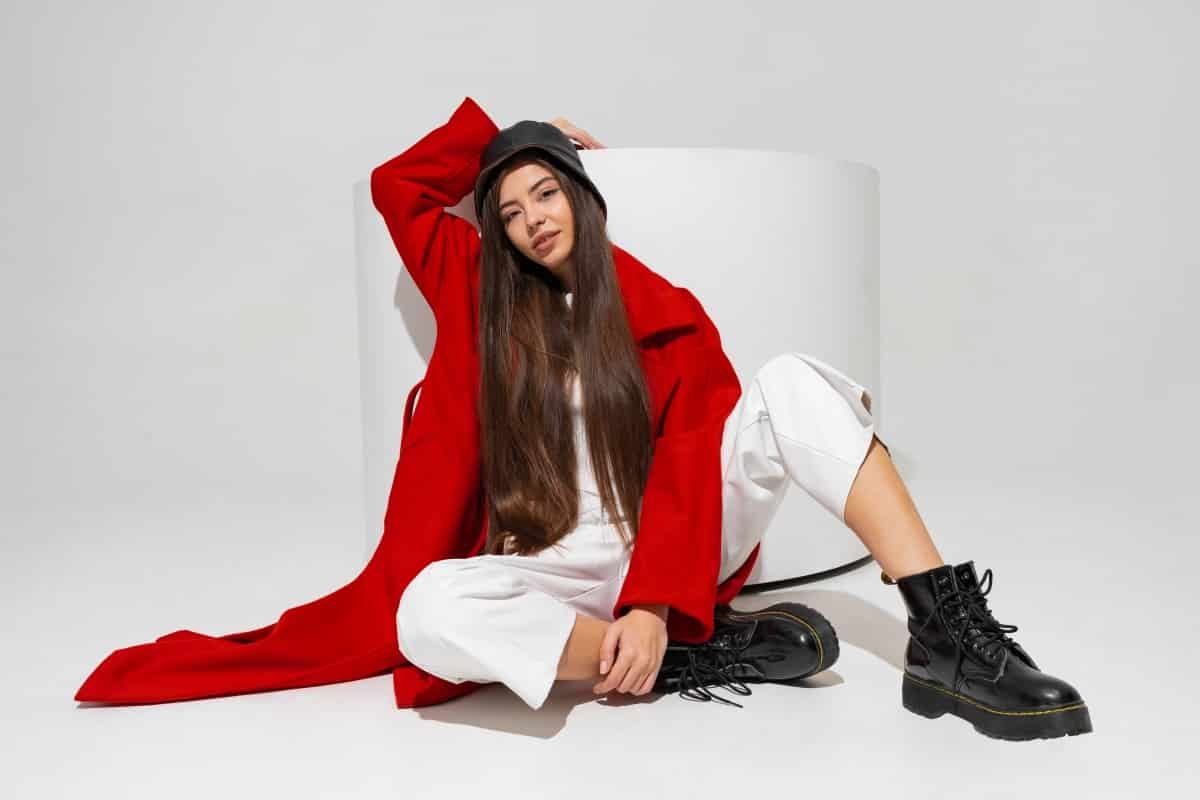 Home fashionable model stylish hat red coat boots posing white wall studio 1.jpg